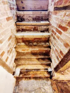 Barrel vaulted brick basement stairs - before